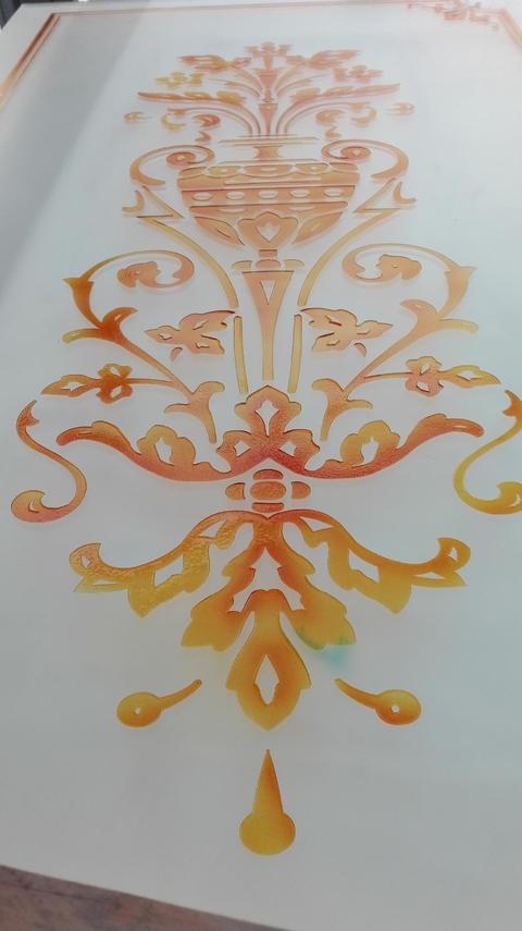 Vetro satinato su cui è stato realizzato un motivo che ricord l' arte classica, arricchito da diversi colori, quali giallo ambra con lievi schiariture, arancio e un leggero tocco di marrone.