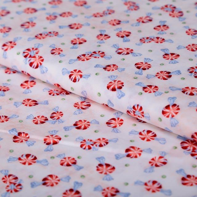 Stoffa Natalizia  con fondo bianco rosato e caramelle stafil 140 cm x 50 cm