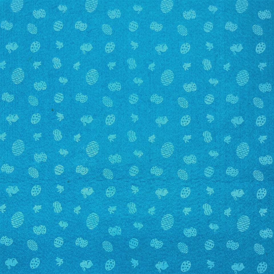 pannolenci stampato turchese con piccoli decori di  uova pasquali e conigli stafil 30 x 40 cm