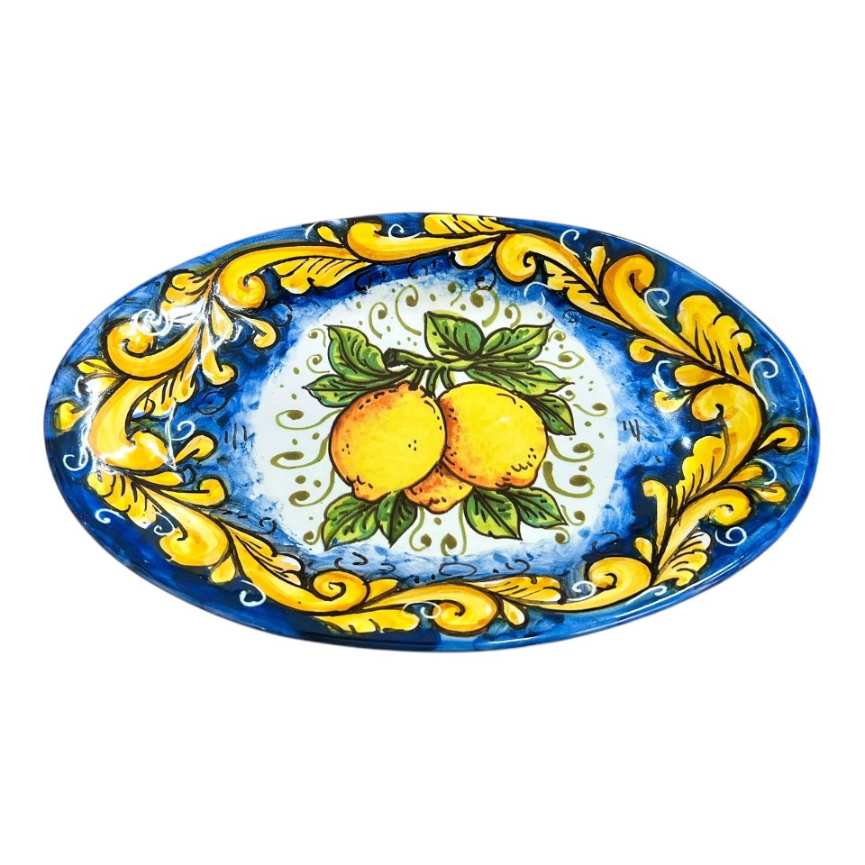 Piatto ornamentale ovale da parete con limoni decoro ornato giallo fondo blu Produzione artigianale di Santo Stefano di Camastra Lunghezza 18cm