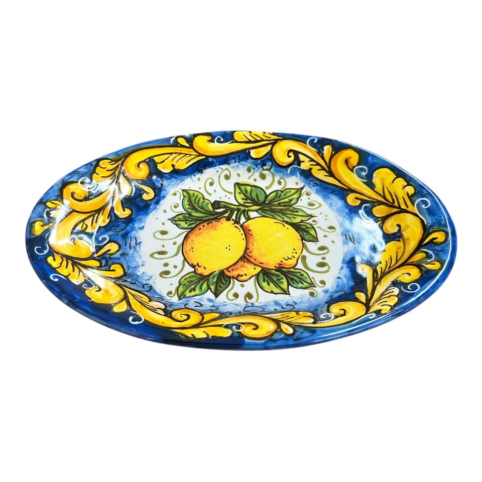 Piatto ornamentale ovale da parete con limoni decoro ornato giallo fondo blu Produzione artigianale di Santo Stefano di Camastra Lunghezza 18cm