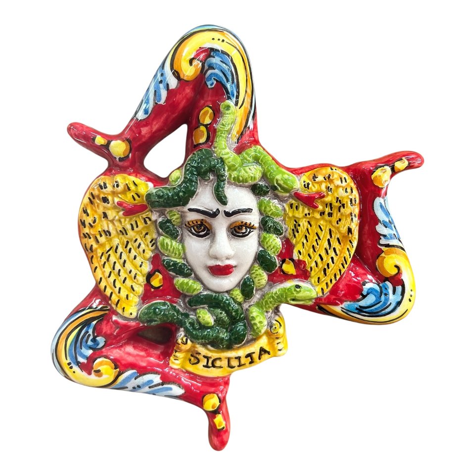 Trinacria ornamentale da parete in ceramica siciliana decoro ornato barocco fondo rosso Produzione artigianale di Caltagirone Lunghezza 17cm