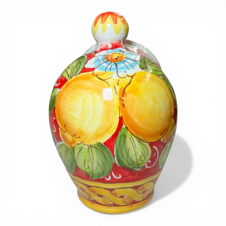 Saliera a salvadanaio in ceramica siciliana decoro con limoni e margherite fondo rosso intrecciato Produzione artigianale di Santo Stefano di Camastra h.20cm