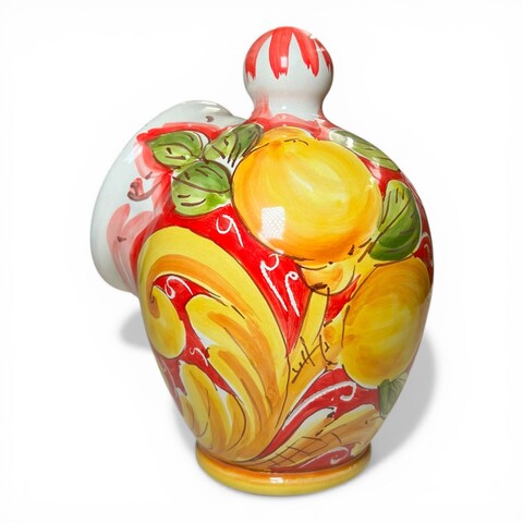 Saliera a salvadanaio in ceramica siciliana decoro barocco giallo con limoni fondo rosso Produzione artigianale di Santo Stefano di Camastra h.20cm