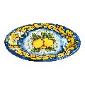 Piatto ornamentale ovale da parete con limoni decoro ornato giallo fondo blu Produzione artigianale di Santo Stefano di Camastra Lunghezza 18cm